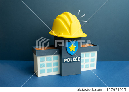 A police building with a yellow construction helmet. Construction and renovation of a police station. Reforms in law enforcement improve infrastructure, modern facilities support public safety systems A police building with a yellow construction helmet. Construction and renovation of a police station. Reforms in law enforcement improve infrastructure, modern facilities support public safety systems 137971925