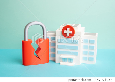 A hospital and a cracked padlock. Medical systems hacked and patients personal data stolen. Cyberattack on healthcare infrastructure and risks to confidential medical information security. 137971932