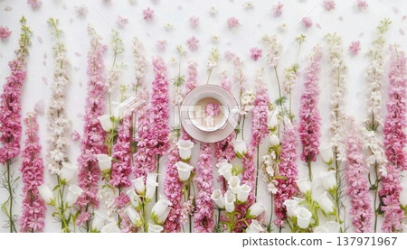 An elegant overhead flat lay captures a serene moment with vibrant pink and delicate white flowers artfully arranged around a charming teacup containing a blooming flower, all set against a pristine An elegant overhead flat lay captures a serene moment with vibrant pink and delicate white flowers artfully arranged around a charming teacup containing a blooming flower, all set against a pristine 137971967