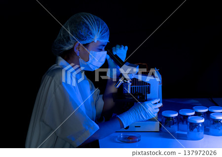 The scientist biologist is working very seriously use microscope The scientist biologist is working very seriously use microscope 137972026