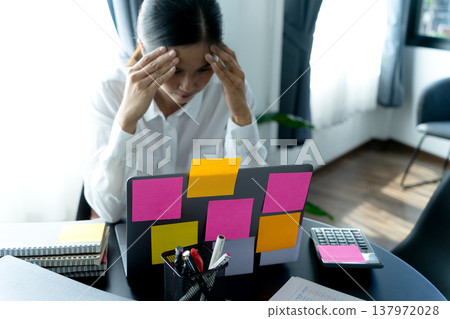 businesswoman looking at laptop with many color notes businesswoman looking at laptop with many color notes 137972028