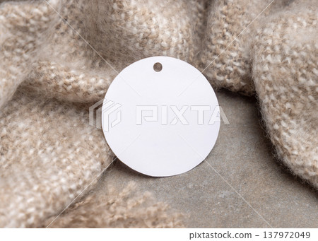 Blank round gift tag mockup on beige plaid, copy space. Handmade product label design Blank round gift tag mockup on beige plaid, copy space. Handmade product label design 137972049