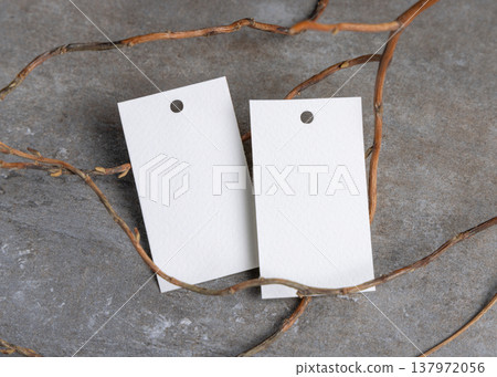 Blank gift tag mockup on grey stone with dry branches, copy space. Handmade product label Blank gift tag mockup on grey stone with dry branches, copy space. Handmade product label 137972056