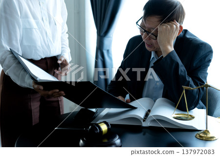 lawyer is listening to the legal text report seriously from the female lawyer is listening to the legal text report seriously from the female 137972083