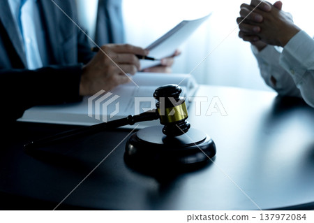 Lawyer is advising worried client using information listened Lawyer is advising worried client using information listened 137972084