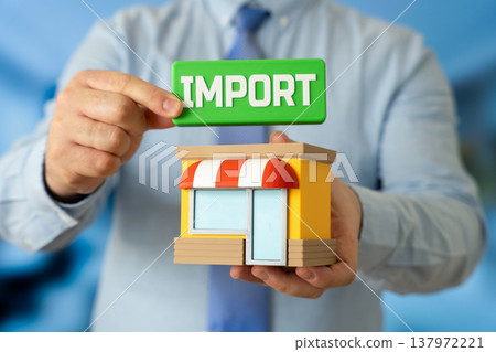 A store and an import sign in the hands of a businessman. Importing goods and replenishing inventory. Global trade supports retail supply chains while introducing new products to competitive markets 137972221