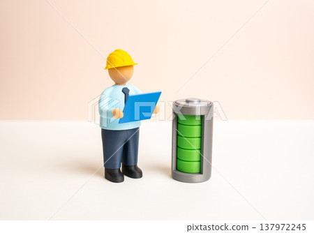 An engineer inspects an energy storage system. Autonomous and energy saving technologies. Innovation in power management improves efficiency and reliability in modern infrastructure An engineer inspects an energy storage system. Autonomous and energy saving technologies. Innovation in power management improves efficiency and reliability in modern infrastructure 137972245
