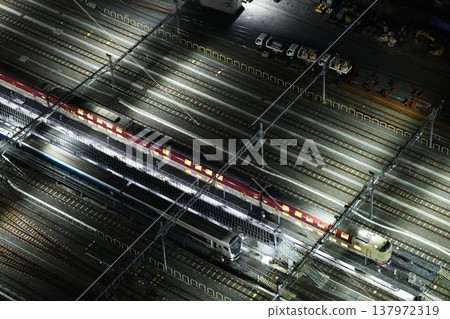 A sleeper express train parked at a train depot at night. A sleeper express train parked at a train depot at night. 137972319