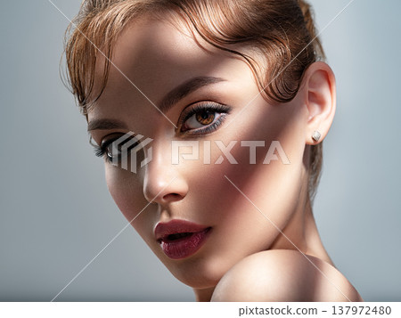 Art portrait of beautiful young woman with brown makeup. Beautiful brunette with hard shadows on her face. Model with short creative hairstyle. Art portrait of beautiful young woman with brown makeup. Beautiful brunette with hard shadows on her face. Model with short creative hairstyle. 137972480