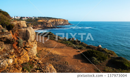 Beautiful natural landscape with ocean rocky shore with blue sky.  Scenic ocean  landscape on summer sunny day.  Beautiful  rocky coast at Santu Isidoro. Portugal. Europe. 137973004