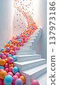 A cascade of colorful pastel spheres flowing down a modern white spiral staircase 137973186