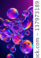 Colorful soap bubbles float in a vibrant purple background. The bubbles display a spectrum of colors, creating a mesmerizing visual effect. 137973189