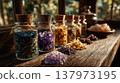 Colorful jars filled with various crystals and salts arranged on a wooden table. Natural light illuminates the scene, creating a warm atmosphere. 137973195