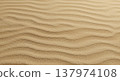The undulating patterns of sand create a mesmerizing texture across the desert landscape evoking a sense of peaceful serenity and natural beauty. 137974108