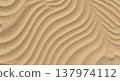 Close up of wavy sand patterns on a beach creates a stunning abstract image evoking tranquility and the rhythmic power of nature itself. 137974112