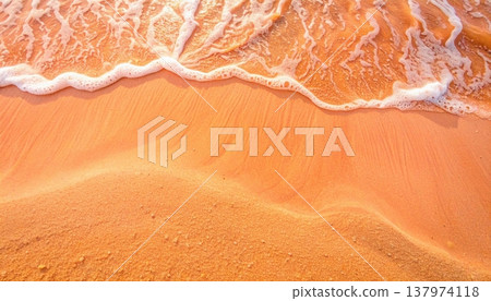 Golden sunlight reflects beautifully on the tranquil shoreline as gentle waves caress the sandy beach creating a soothing and peaceful scene. Golden sunlight reflects beautifully on the tranquil shoreline as gentle waves caress the sandy beach creating a soothing and peaceful scene. 137974118