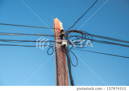 old wooden pole with electrical wires old wooden pole with electrical wires 137974333