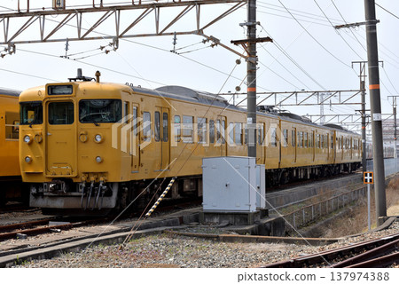 Three 115 series electric train cars parked at the train depot. Three 115 series electric train cars parked at the train depot. 137974388