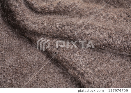 Natural hand-knitted wool shawl close-up 137974709