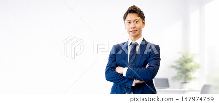 A businessman with his arms crossed. 137974739