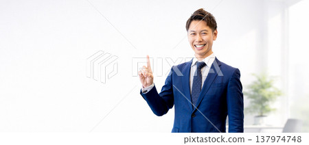 A male businessman pointing his index finger to guide you 137974748