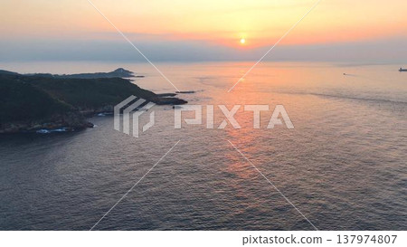 Sunset view of Suzaki on the Izu Peninsula. Calm sea and sunset around Ebisu Island (aerial view). 137974807