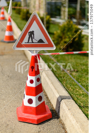 Roadwork cone with warning sign Roadwork cone with warning sign 137975049
