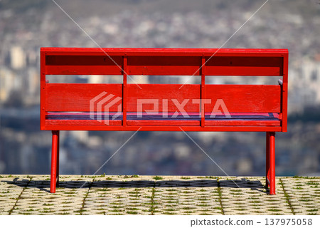 Red bench with blurred city view background Red bench with blurred city view background 137975058