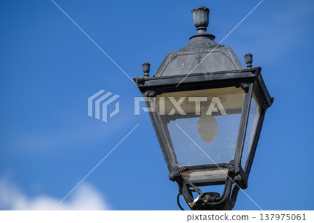Vintage street lantern against blue sky 137975061