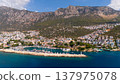 Aerial drone view of Kas town in Turkey with marina, boats and mountains. Scenic Mediterranean coastline with turquoise sea and summer travel atmosphere. 137975078