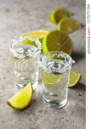 Tequila with salt and lime slices. 137975764