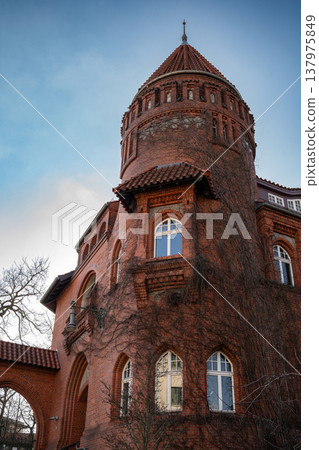 Red Brick Tower and Facade with Ivy in Vertical Composition 137975849