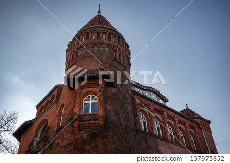 Historic Red Brick Tower Against a Blue Sky 137975852
