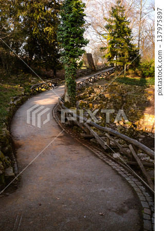 Curving Park Path with Rustic Fence and Small Dog Curving Park Path with Rustic Fence and Small Dog 137975897