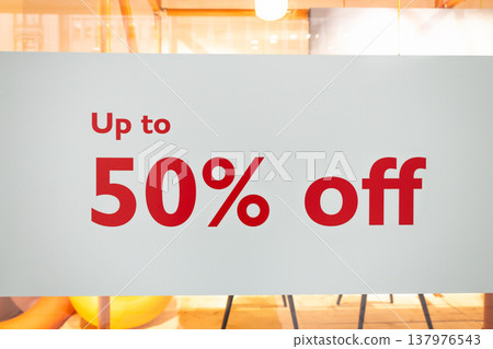 Retail store window sign advertising up to fifty percent off sale Retail store window sign advertising up to fifty percent off sale 137976543