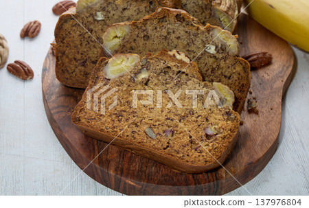 Homemade Banana Bread Slices with Nuts on Board 137976804