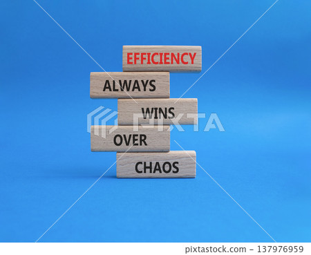 Efficiency symbol. Wooden blocks with words Efficiency Always Wins Over Chaos. Beautiful blue background. Businessman hand. Business and Efficiency concept. Copy space Efficiency symbol. Wooden blocks with words Efficiency Always Wins Over Chaos. Beautiful blue background. Businessman hand. Business and Efficiency concept. Copy space 137976959