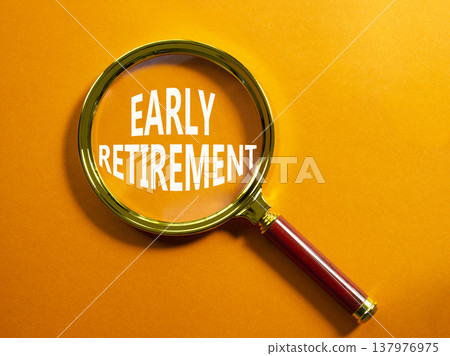 Early Retirement symbol. Magnifying Glass with words Early Retirement. Beautiful orange background. Business and Early Retirement concept. Copy space. 137976975