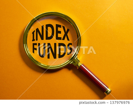 Index Funds symbol. Magnifying Glass with words Index Funds. Beautiful orange background. Business and Index Funds concept. Copy space. 137976976
