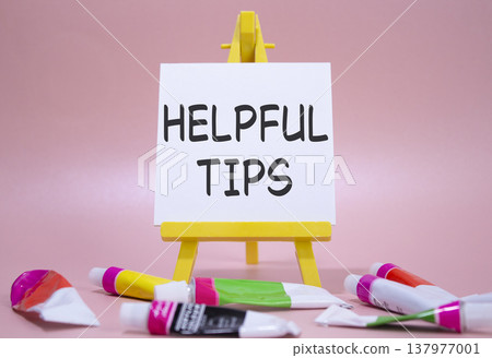Helpful tips symbol. Wooden blocks with words Helpful tips. Beautiful pink background with paints and easel. Business and Helpful tips concept. Copy space. Helpful tips symbol. Wooden blocks with words Helpful tips. Beautiful pink background with paints and easel. Business and Helpful tips concept. Copy space. 137977001