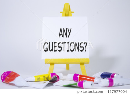 Any Questions symbol. Wooden blocks with words Any Questions . Beautiful white background with paints and easel. Business and Any Questions concept. Copy space. 137977004