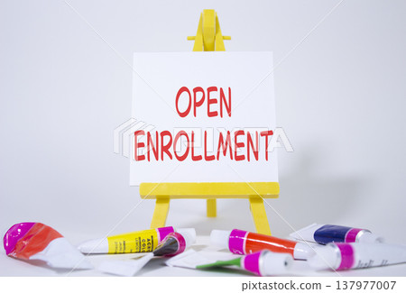 Open Enrollment symbol. Wooden blocks with words Open Enrollment. Beautiful white background with paints and easel. Business and Open Enrollment concept. Copy space. Open Enrollment symbol. Wooden blocks with words Open Enrollment. Beautiful white background with paints and easel. Business and Open Enrollment concept. Copy space. 137977007
