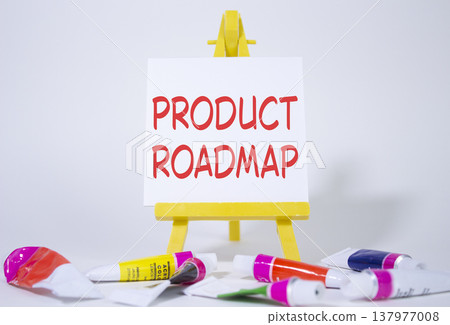 Product Roadmap symbol. Concept word Product Roadmap on wooden blocks. Beautiful white background with paints and easel. Business and Product Roadmap concept. Copy space Product Roadmap symbol. Concept word Product Roadmap on wooden blocks. Beautiful white background with paints and easel. Business and Product Roadmap concept. Copy space 137977008