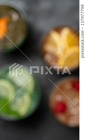 Vertical blurred cocktail background colorful drinks Vertical blurred cocktail background colorful drinks 137977799