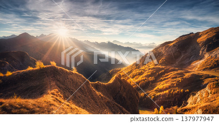 Mountains in low clouds at beautiful sunset in autumn in Italy Mountains in low clouds at beautiful sunset in autumn in Italy 137977947
