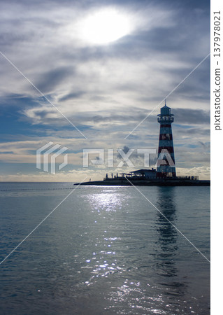 Vertical shot of a summer cloudy afternoon with a lighthouse in the background.Copy space. Banner for travel promotion Vertical shot of a summer cloudy afternoon with a lighthouse in the background.Copy space. Banner for travel promotion 137978021