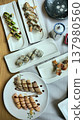 Delicious Assortment of Sushi Rolls on Elegant Plates 137980560