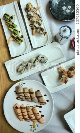 Delicious Assortment of Sushi Rolls on Elegant Plates Delicious Assortment of Sushi Rolls on Elegant Plates 137980560