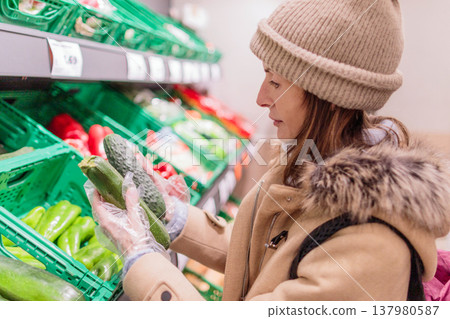 Woman choosing vegetables, focusing on healthy eating and diet Woman choosing vegetables, focusing on healthy eating and diet 137980587