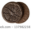 Two dark chocolate cookie wafers with an embossed floral pattern isolated. These cocoa flavored biscuits are perfect for snacks or recipe ingredients. Studio shot. 137982238